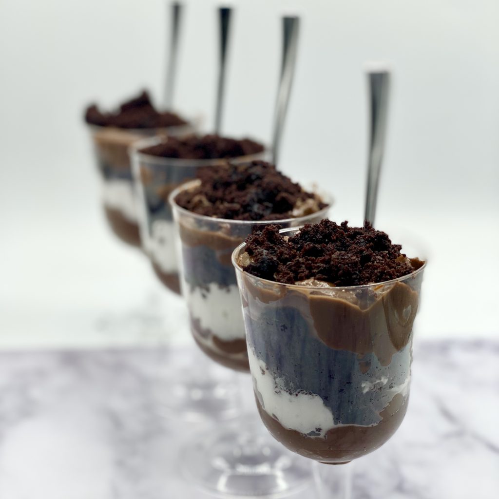 Chocolate Cake Pudding Cups Linned Up With Spoons in them