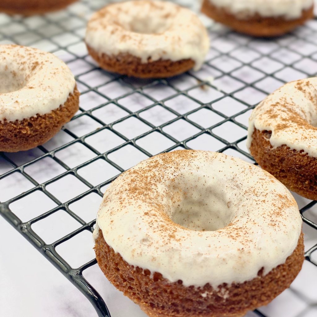 Carrot Cake Doughnuts With Icing and Cinnamon Powder on Top