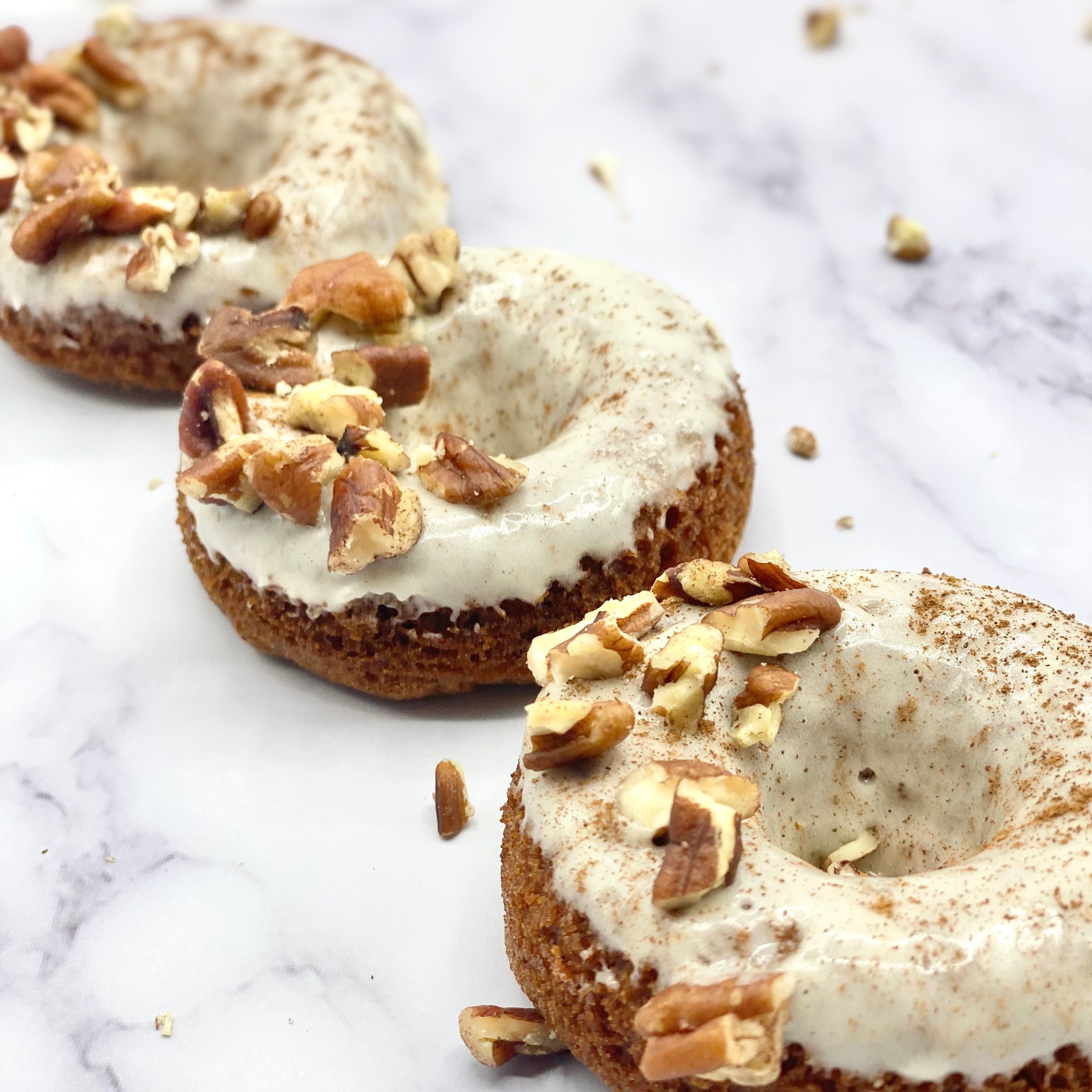 Carrot Cake Doughnuts With Icing, Cinnamon Powder and Nuts