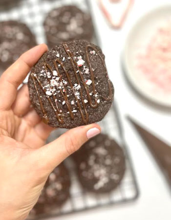 A woman holding a Double Chocolate Peppermint Cookie