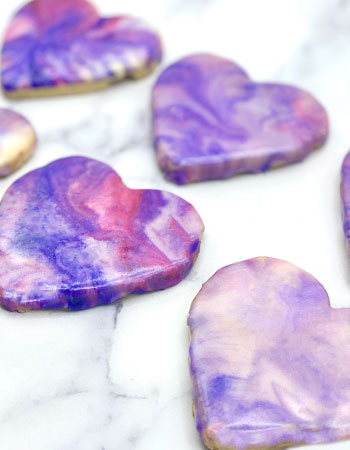 Heart shape violet sugar cookies on the white table