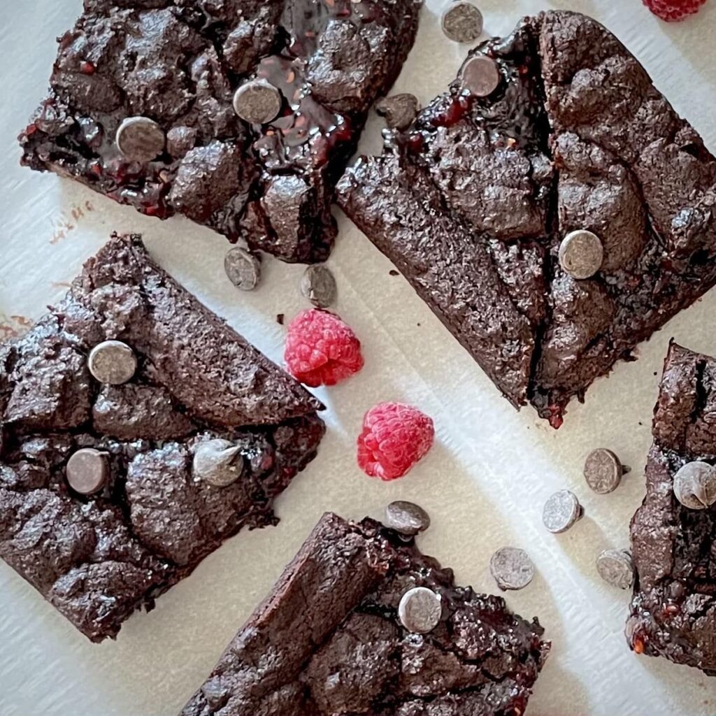 Double Chocolate Raspberry Cookie Bars on a Surface