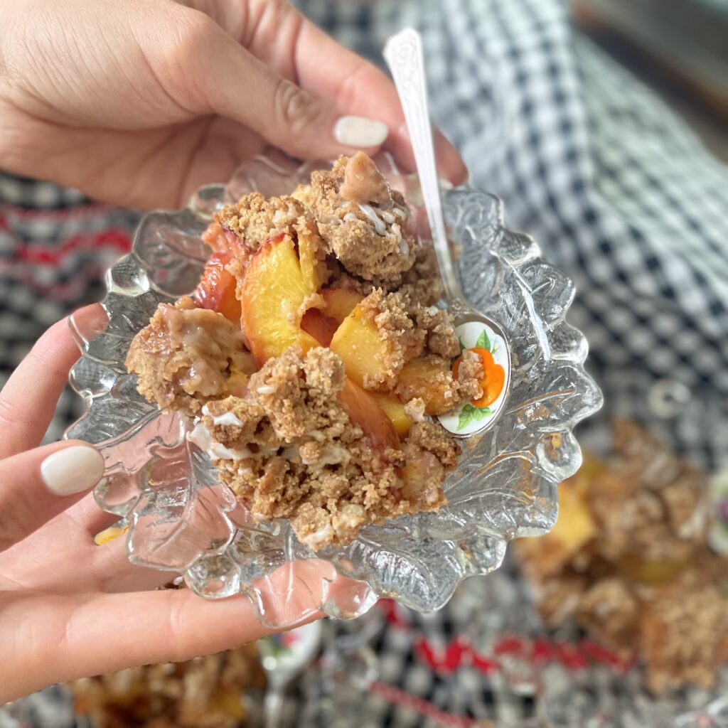A Serving of Peach Cobbler on a Glass Bowl