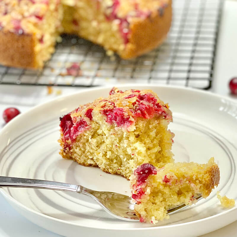 Cranberry Corn Bread Slice on a White Plate With a Fork