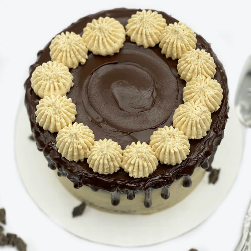 A Rustic Peanut Butter Cake garnished with chocolate